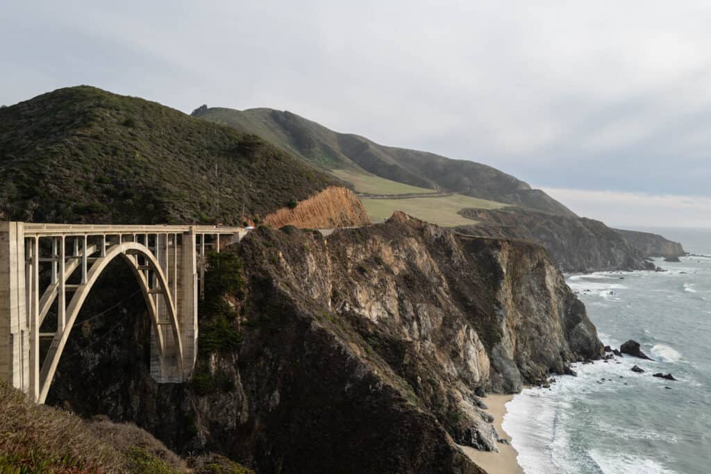 The Bixby Bridge in Monterey County and a sandy beach along the Pacific Ocean