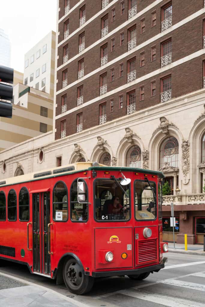 red trolly in front of the Adolphus Hotel in Dallas