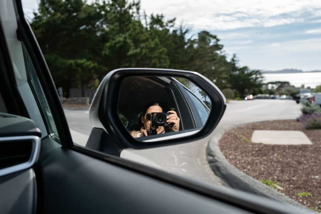 Taking a self portrait in the side mirror of a car on a Leica Q2